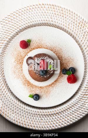 Beautiful chocolate lava cake coulant from a top view with christmas decorations. Stock Photo