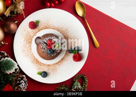 Beautiful chocolate lava cake coulant from a top view with christmas decorations. Stock Photo