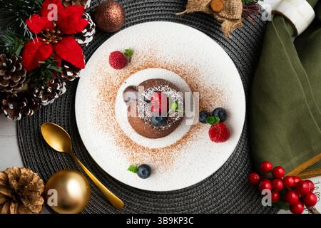 Beautiful chocolate lava cake coulant from a top view with christmas decorations. Stock Photo