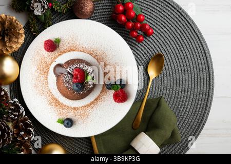 Beautiful chocolate lava cake coulant from a top view with christmas decorations. Stock Photo