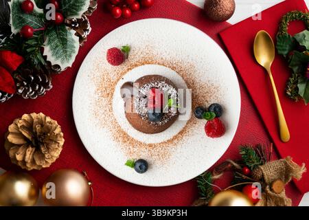 Beautiful chocolate lava cake coulant from a top view with christmas decorations. Stock Photo