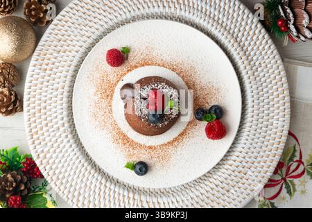 Beautiful chocolate lava cake coulant from a top view with christmas decorations. Stock Photo