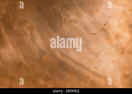 Empty copper background with brushed polished texture. Natural light in the right. Design backdrop. Copy space. Stock Photo