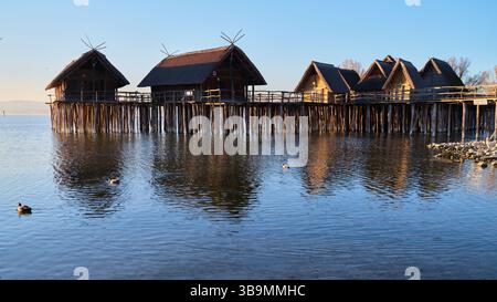 Wooden houses on stilts reflecting in the Amazon River, Amazonas state ...