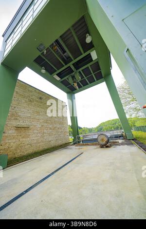 Industrial structure with green construction and machinery on an outdoor concrete floor, Glems reservoir, Swabian Alb, Germany, Europe Stock Photo