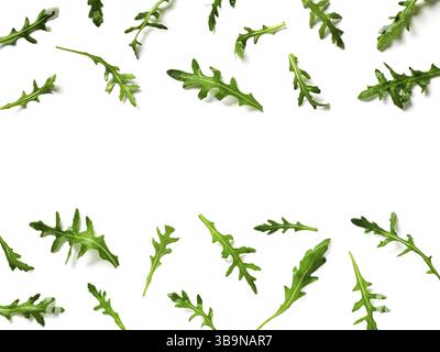 Arugula pattern with copy space in center. Arugula isolated on white with clipping path. Frame made of arugula leaves. Flat lay, top view Stock Photo