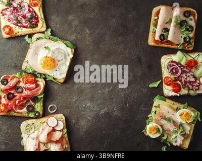 Set of eight different sandwiches with meat, copy space for design or text in center. Top view or flat lay. Assortment meat toasts on black background Stock Photo