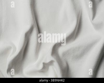 White cotton fabric texture. Clothes cotton jersey background with folds Stock Photo
