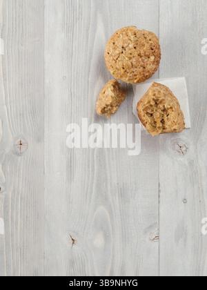 Top view of muffin with zucchini, carrots, apple and cinnamon on gray wooden background. Sweet vegetables homemade muffins. Toddler-friendly recipe id Stock Photo
