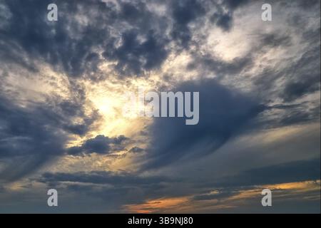 Heavy dark clouds at sunset. Sky background. Cloudy weather before rain. Gloomy mood Stock Photo