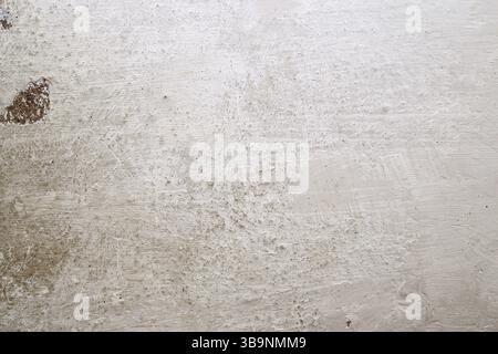 Texture of a whitewashed wall with scuffs, scratches and dirty spots. White textured background Stock Photo
