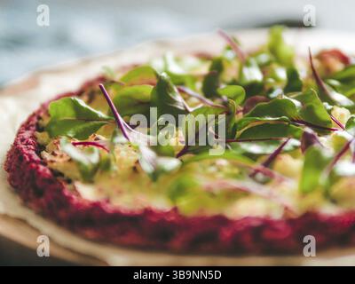 Beetroot pizza crust with fresh swiss chard or mangold, beetroot leaves. Ideas and recipes for vegan snack.Egg-free pizza crust with chia seeds and wh Stock Photo