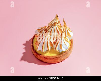 Mini cake decorated with whipped egg whites meringue. Mini lemon tart with burnt French meringue. Delicious dessert with lemon filling. topped with me Stock Photo