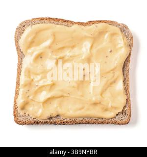 Bread slice with mustard sauce isolated on white, clipping path. Slice of multigrain bread square form plaster mustard sauce for toast. Image of one s Stock Photo