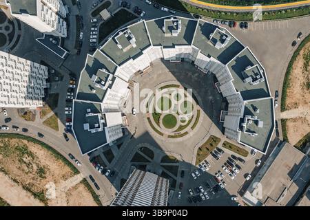 Drone view of semicircle modern high-rise apartments. Aerial top down view on modern semi-circle multi-storey apartment complex with beautiful landsca Stock Photo