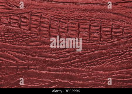 Crocodile genuine leather structure texture macro, red colored leatherette surface with metallic, pearlescent effect. Reptile skin close up, macro bac Stock Photo
