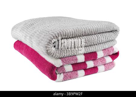 Soft fluffy striped grey and pink bath towels folded in stack isolated on white background. Terry cloth, striped pattern towel texture, cotton bath te Stock Photo