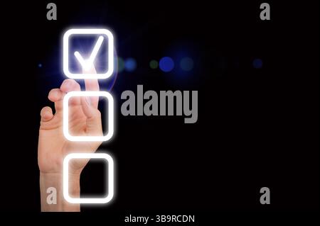 A glowing checkmark on a digital checklist, symbolizing completion and success. The finger taps the touchscreen to validate choices, representing task Stock Photo