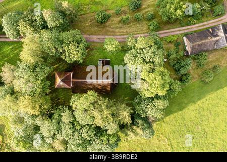 Aerial view of a rustic house nestled in a vibrant autumn landscape ...