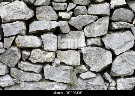 Natural stone wall made of large stones Stock Photo
