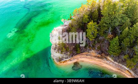 Photo of Miners Castle Rock at Pictured Rocks National Lakeshore Michigan during sunset with golden light over cliffs and Lake Superior. Stock Photo