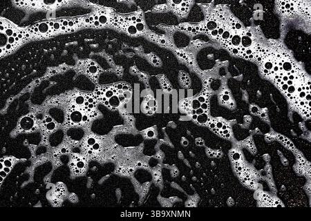 Black and white soap bubbles. Abstract foam closeup surface. Wet cleaning texture macro. Monochrome pattern of washing liquid. Bathroom detergent. Stock Photo