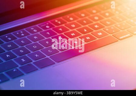 Detail of a laptop keyboard with blue and red light Stock Photo