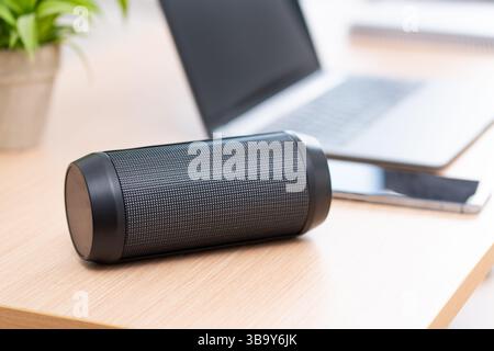 Close-up of wireless black speaker on a table at office Stock Photo