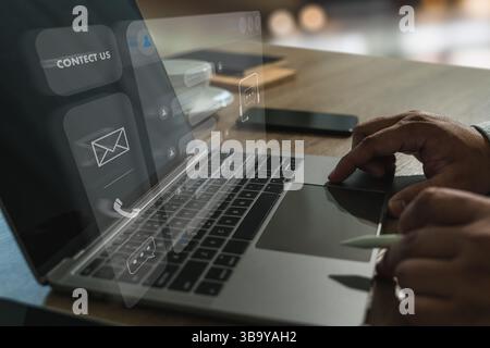 Businessman using AI chatbot interface on laptop for digital contact center support. Modern communication and customer service technology concept in a Stock Photo