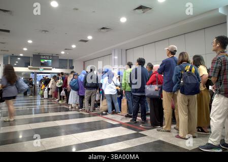Singapore - 29 November 2024: Queue of people at the port in Singapore who will travel to Batam, Indonesia using a ferry. Stock Photo