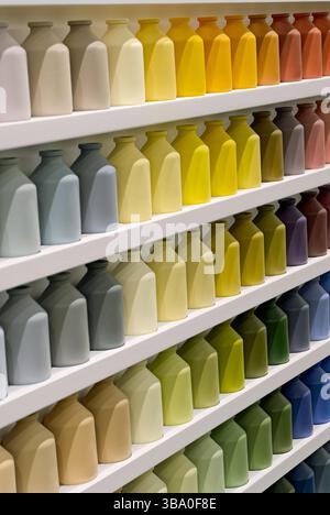Many small jars of the same shape and size, different colors, close up shot, abstract background Stock Photo