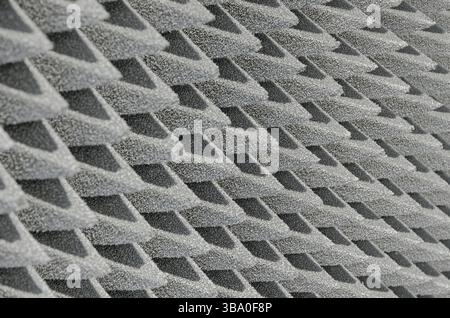 Embossed sound-absorbing panel, close up shot, abstract grey background Stock Photo