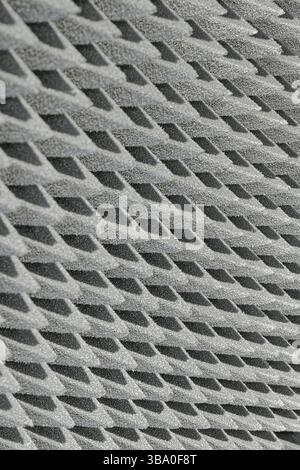 Embossed sound-absorbing panel, close up shot, abstract grey background Stock Photo