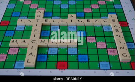 The concept of AI is illustrated on a Scrabble board with the words Robot, Machine, Learning, Artificial Intelligence spelled out in letters Stock Photo