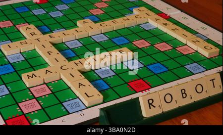 The concept of AI is illustrated on a Scrabble board with the words Robot, Machine, Learning, Artificial Intelligence spelled out in letters Stock Photo