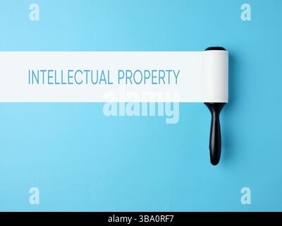 Intellectual property, property rights and trademark concept. Lint roller with white trace on blue background. Stock Photo