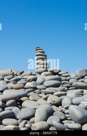 stack of stones built for fun on top of The Pebbleridge, Pebble Ridge natural feature on the beach at Westward Ho! Northam Burrows, North Devon. Stock Photo