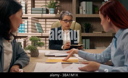 Teamwork Caucasian leader briefing office Asian workers women colleagues co-workers company meeting negotiation partners talking discussion business Stock Photo