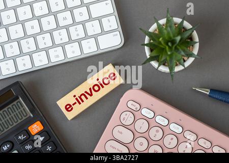 E-invoice and digital billing concept, E-invoice symbol on wooden block. Electronic statement management. Online invoice processing, modern tax accoun Stock Photo