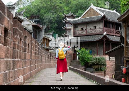 Young female tourist looking at the beautiful landscape of Feng Huang Ancient Town, The famous tourist destination at Hunan Province, China Stock Photo