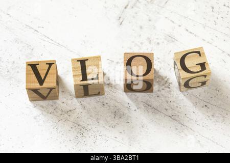 Four wooden cubes with word VLOG (meaning Video Blog) on white working board, Liptovsky Hradok, Slovakia, Europe Stock Photo