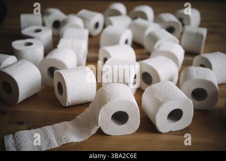 Stack of white tissue toilet paper rolls lying on the floor next to each other Stock Photo