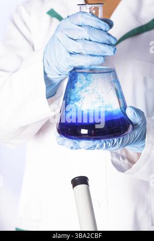 Scientist shows a diffusion in the flask Stock Photo