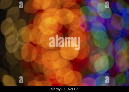 Multi-colored large bokeh spots of blue, yellow and orange. Bokeh from a Christmas garland Stock Photo