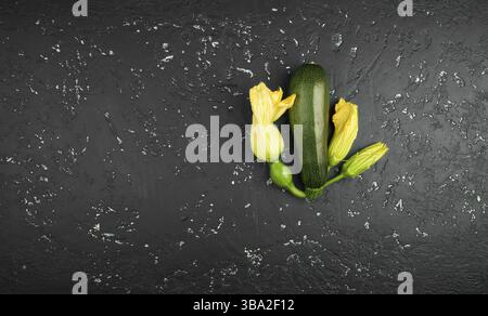 Fresh green zucchini on a dark table. The view from the top. Copy space Stock Photo