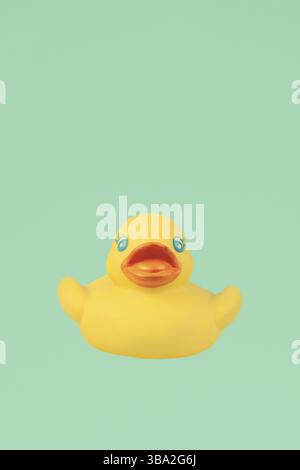 Yellow rubber duck on an emerald background Stock Photo