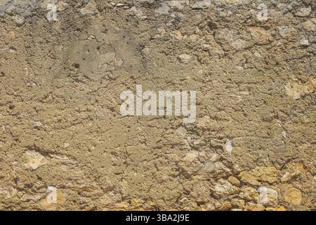 Old, rustic corroded and damaged stone and plaster wall. High quality texture and background for your projects and creative work Stock Photo