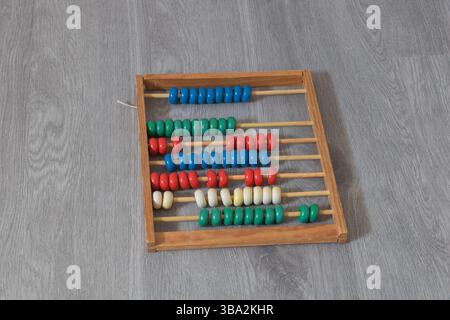 Close-up of a colorful wooden abacus with beads for learning and education. Stock Photo
