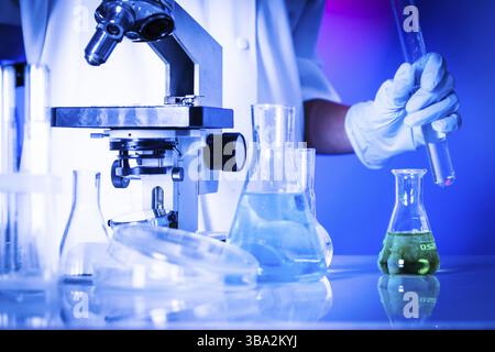 Scientist in the chemical laboratory is doing experiments Stock Photo