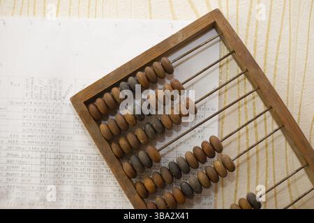 Old wooden abacus on the background of charts Stock Photo
